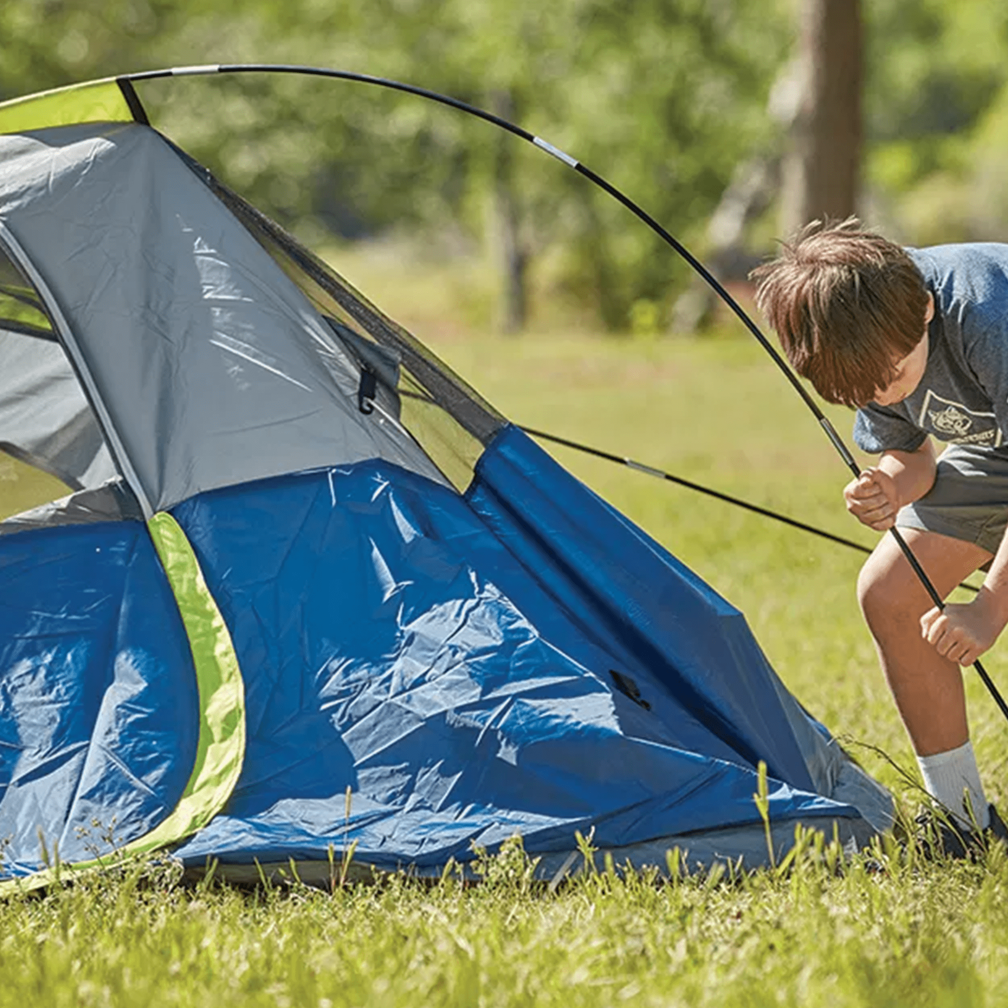 Kid putting up tent